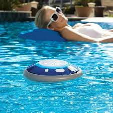 Person lounging in a pool with a blue and gray pool toy.