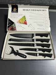 Set of knives and a peeler in a box with 'Design Your Kitchen' branding.
