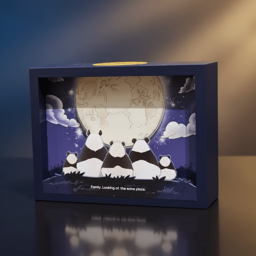 Decorative box with panda design and night sky illustration on a reflective surface.