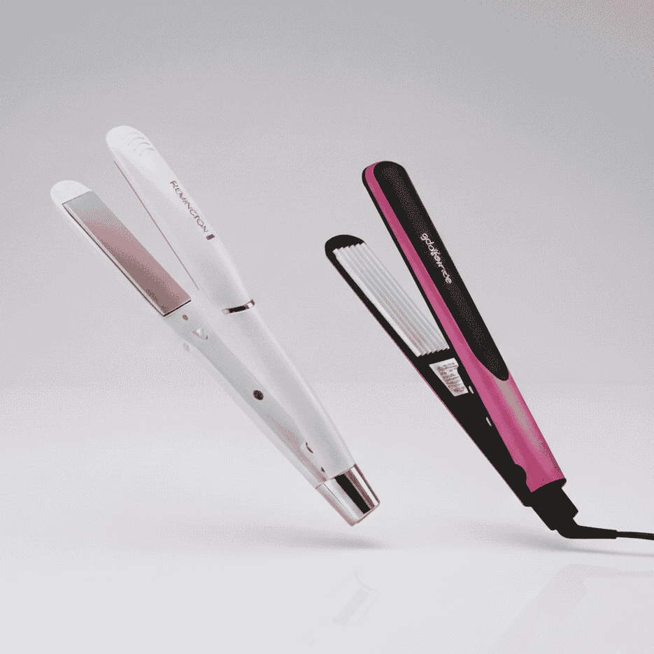 White and pink hair straighteners on a light gray background