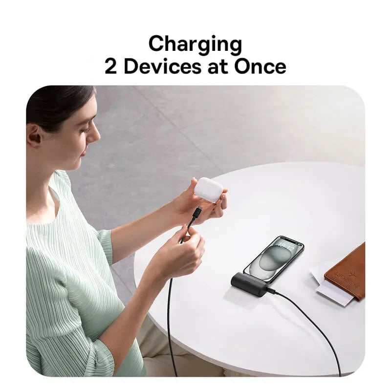 Woman using a baseus charging cable to charge two devices at once, with the brand logo visible.